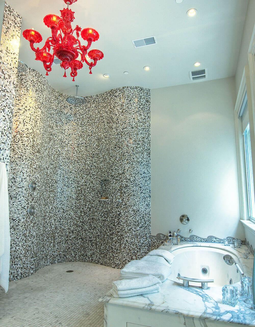 Marble shower and bathtub with red chandelier