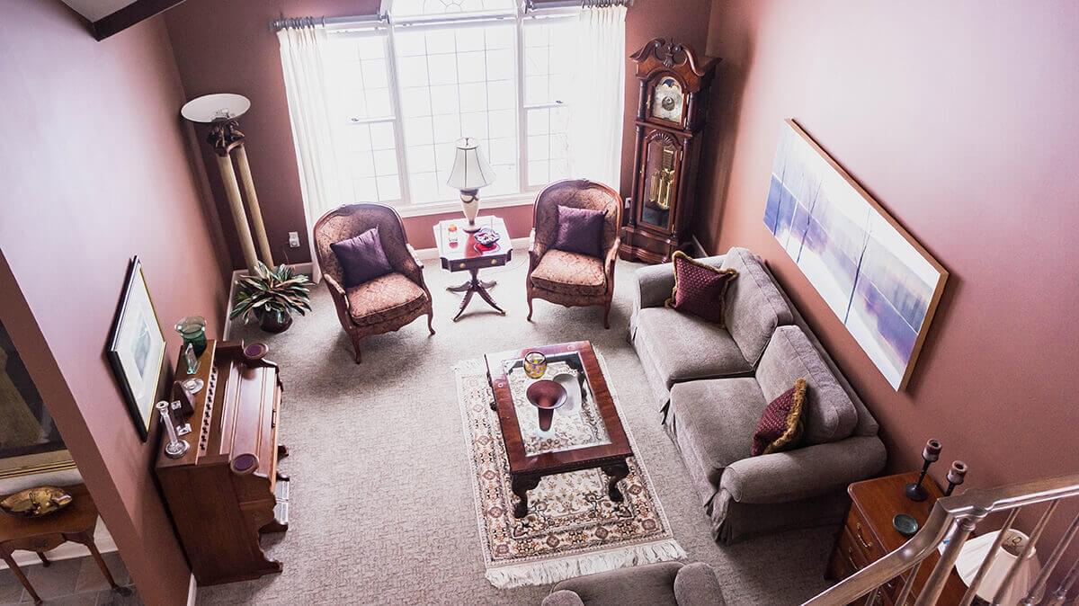 Living room with sofa, clock and two chairs from above