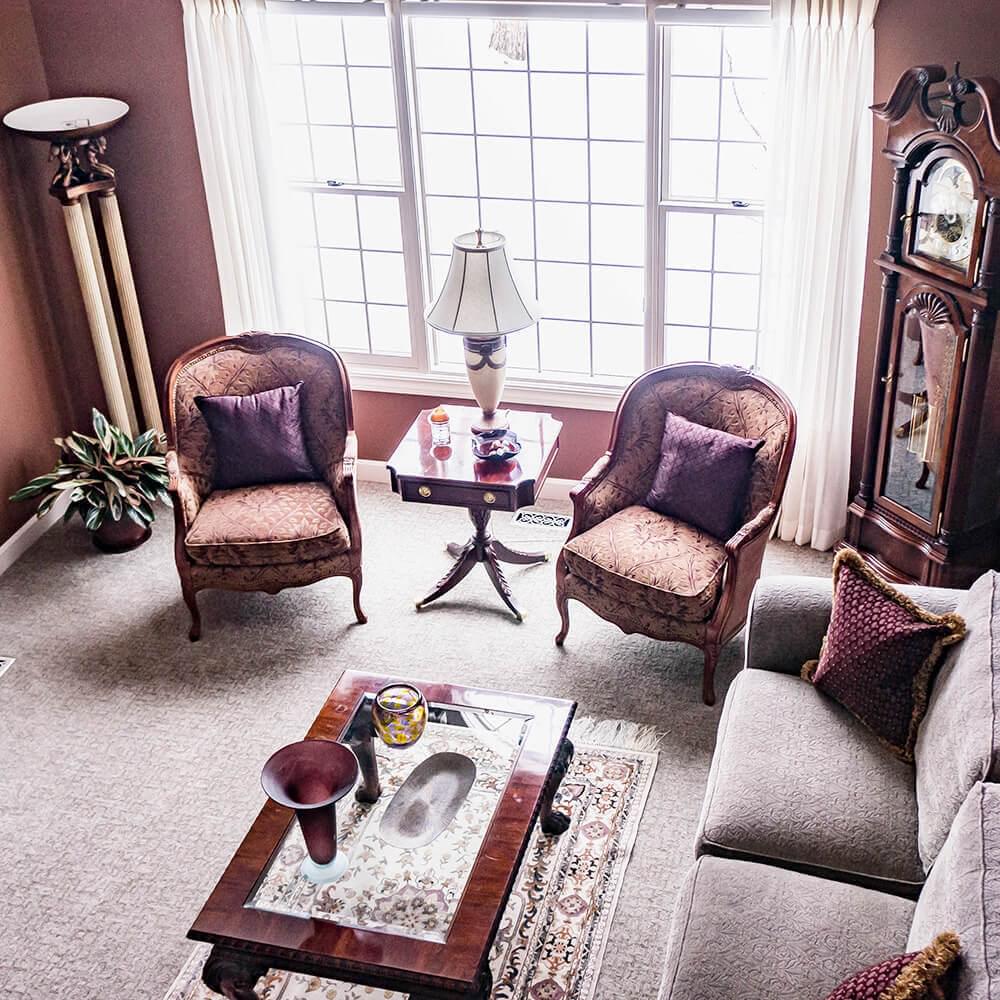 Living room with sofa, clock and two chairs from above